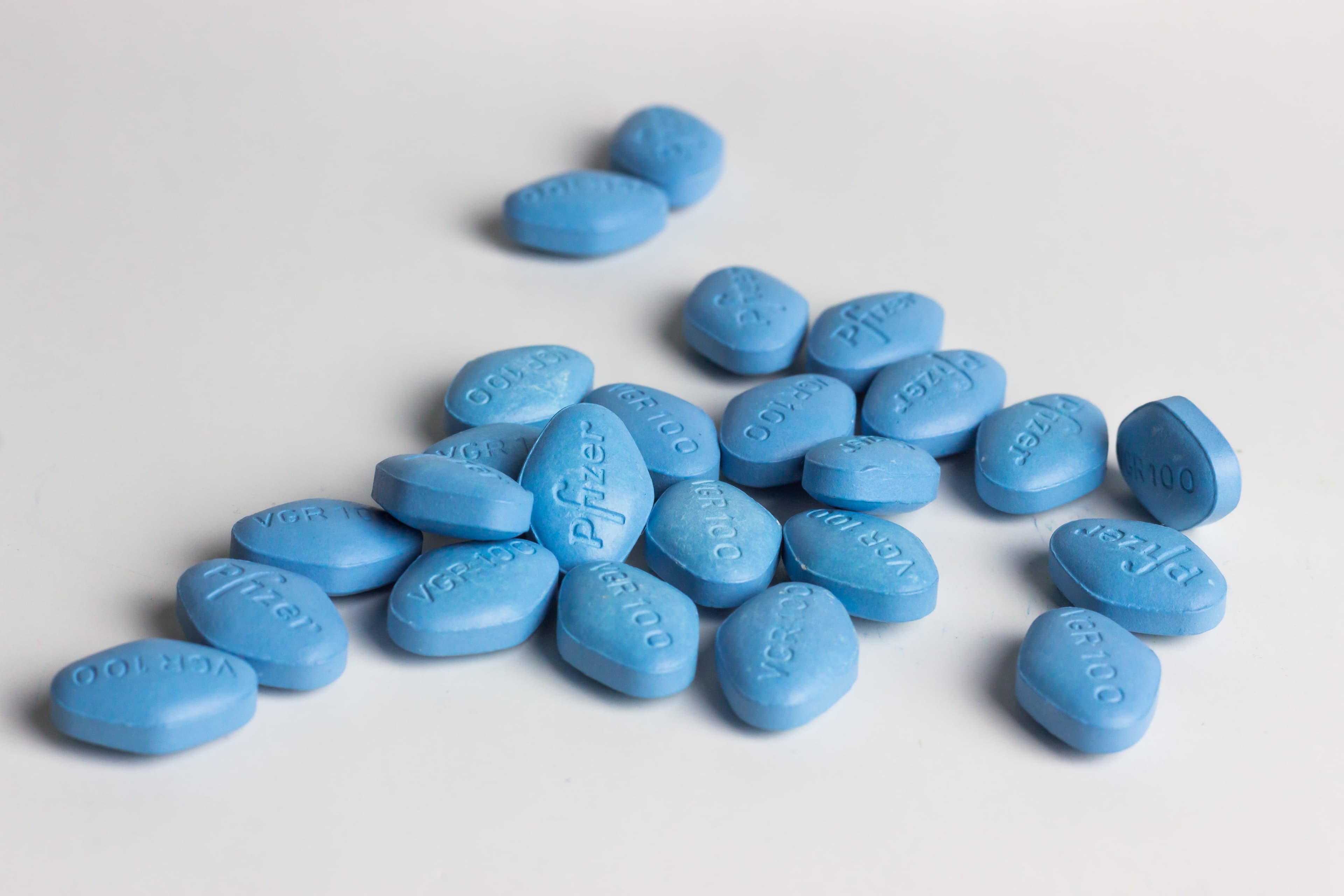 Blue Viagra tablets arranged on a white surface, illustrating the topic of developing tolerance to Viagra over time.